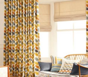 natural roman blinds and floral curtains