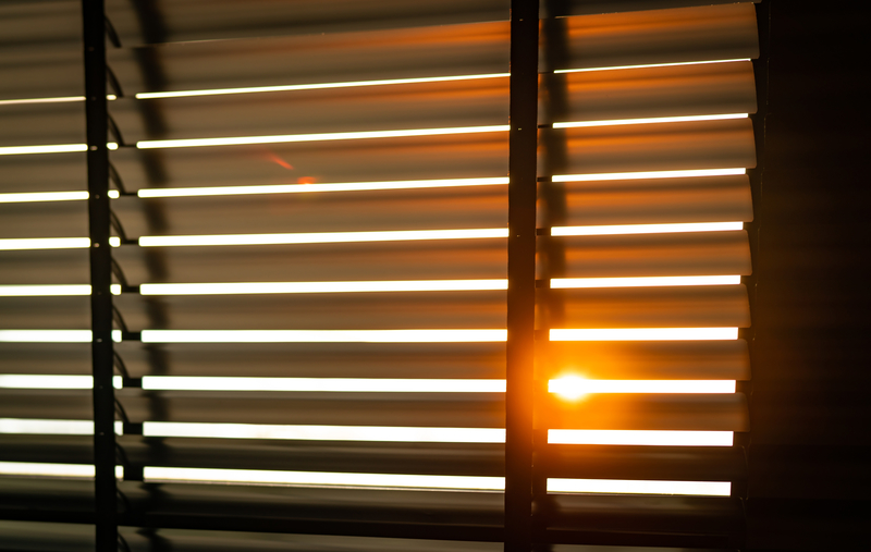 Venetian blinds with sunlight coming through window 