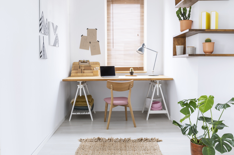 Desk by window with wooden blinds