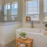 Modern bathroom with white wooden blinds