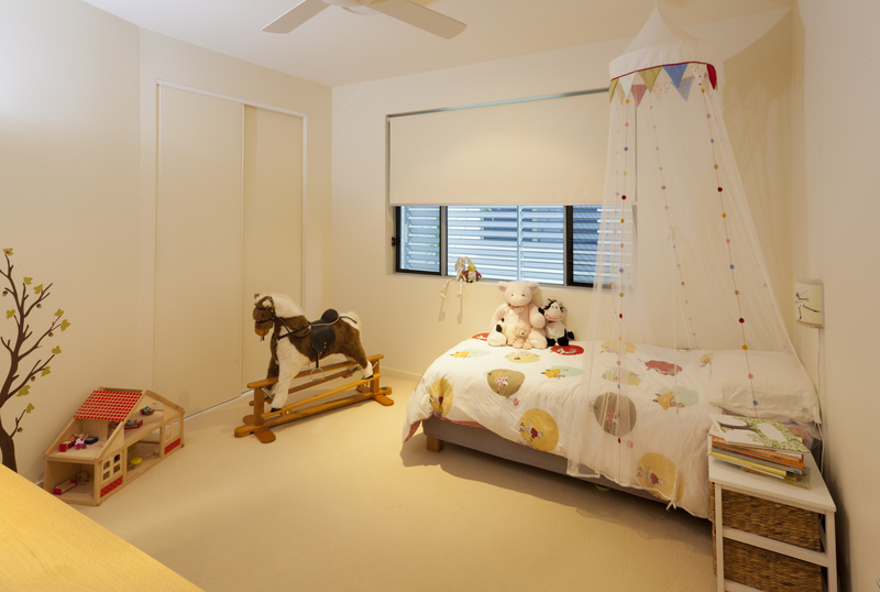 Kids bedroom with white roller blind